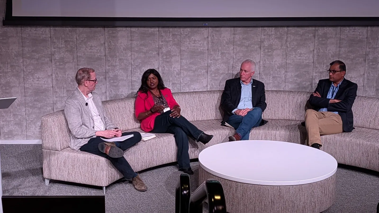 Four panelists exchanging ideas during a seated discussion